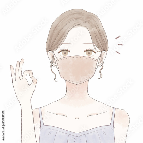布マスクをしている、OKサインを出す女性