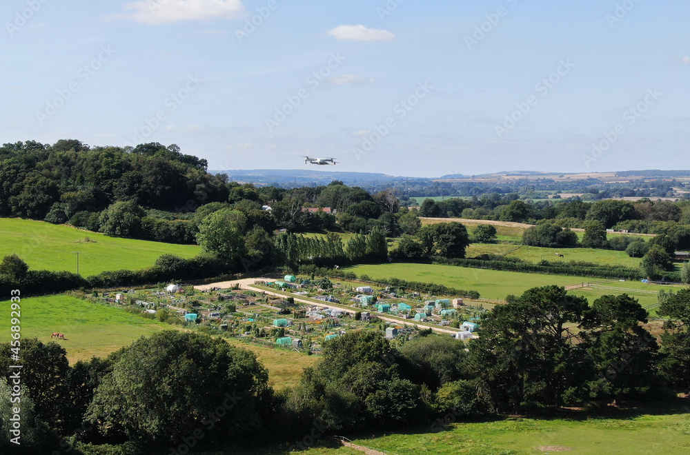 aerial view of a drone flying above an allotment in a rural setting aerial view of a drone flying above an allotment in a rural setting