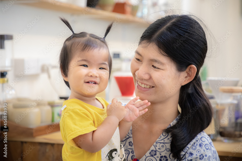 Portrait of cute Asian baby girl and mom at home Portrait of cute Asian baby girl and mom at home