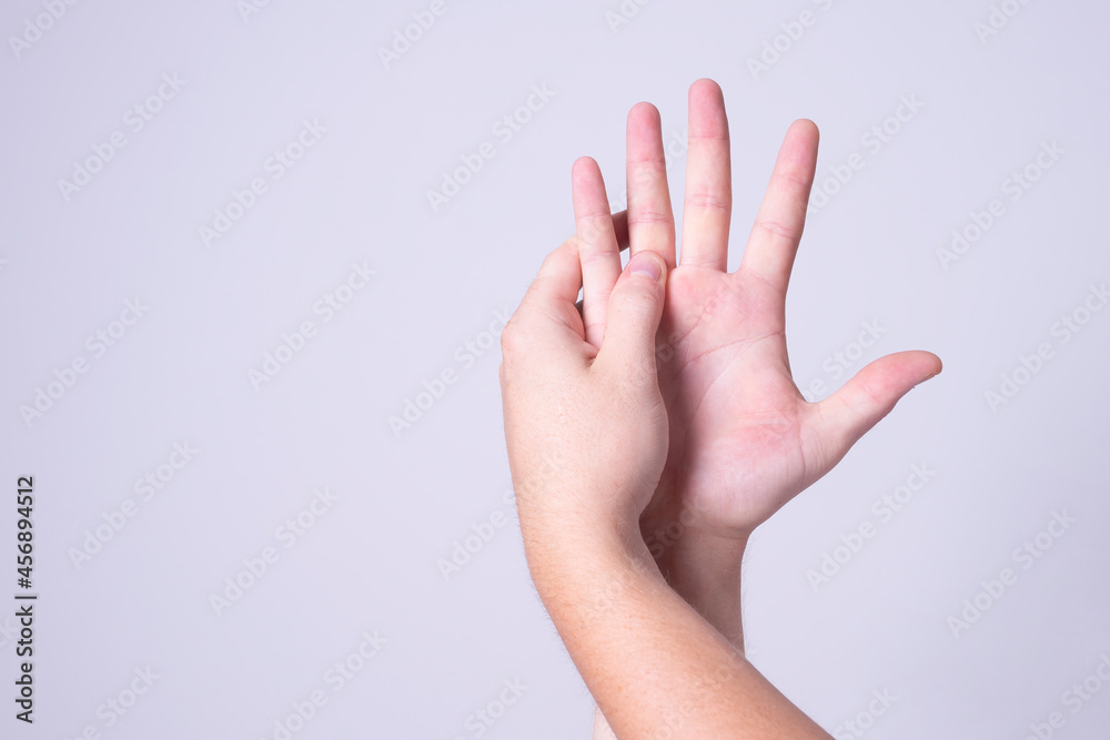 a man massages his hands from chilling pain a man massages his hands from chilling pain