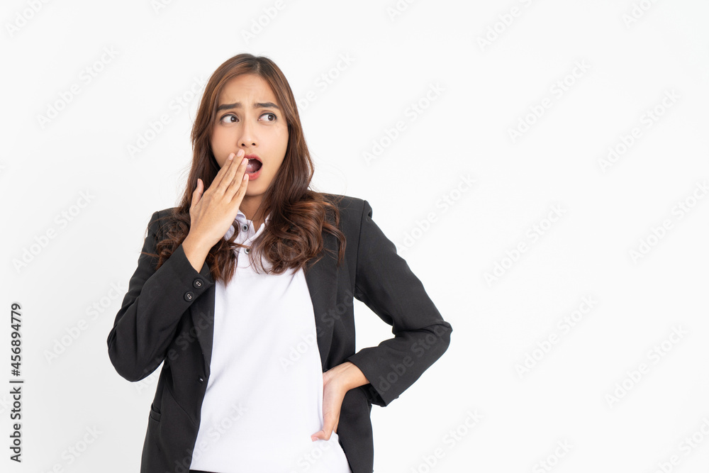 Excited young businesswoman surprised with hands in front of mouth and eyes glancing sideways with space Excited young businesswoman surprised with hands in front of mouth and eyes glancing sideways with space