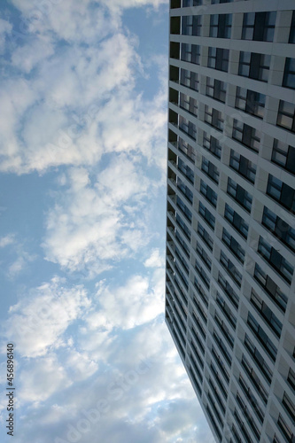 The wall of a modern building against a blue sky.