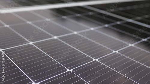 Close-up of modern photovoltaic solar battery panels. Rows of sustainable energy solar panels installed on terrace. Solar panels on roof top. Panels at home. Photovoltaic solar panel extreme close up