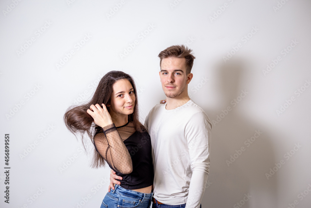 Portrait of young couple in front of white background Portrait of young couple in front of white background