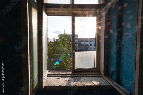 the open window of an abandoned house