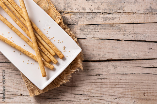 Obraz na płótnie Breadstick grissini snack on rustic wooden table.Copy space