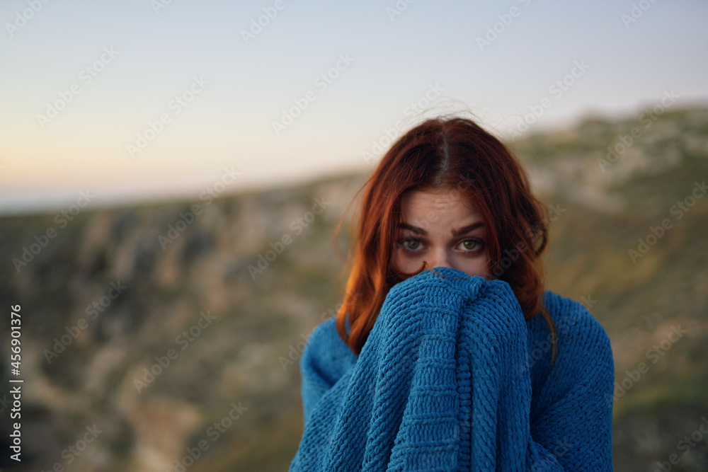 red-haired woman in nature hiding with a blanket travel evening red-haired woman in nature hiding with a blanket travel evening
