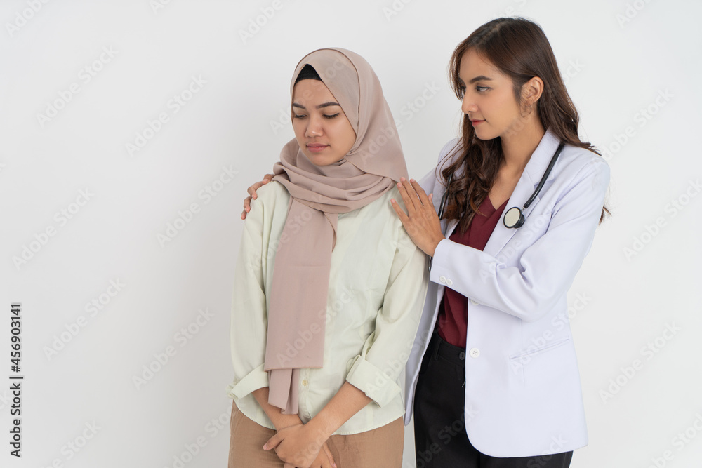 worried woman in headscarf and female doctor with space worried woman in headscarf and female doctor with space