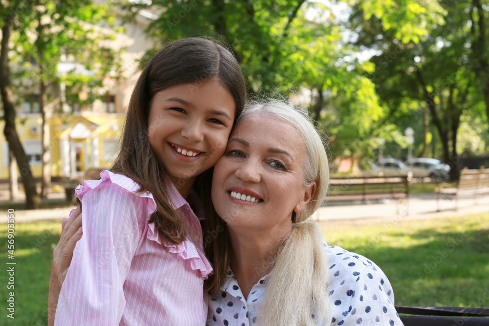 Mature woman with her little granddaughter in park Mature woman with her little granddaughter in park