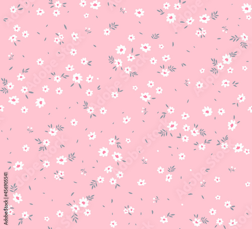 Spring flowers print. Vector seamless floral pattern. Floral design for fashion prints. Endless print made of small white flowers. Elegant template. Pale pink background. Stock vector.