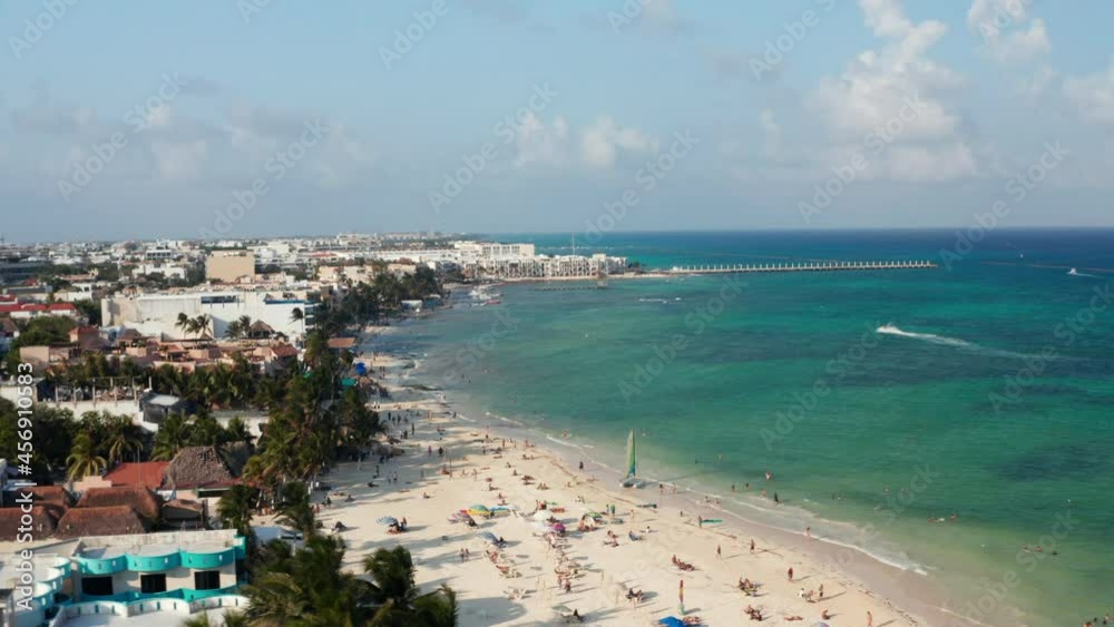 Tourists sunbathing on the sandy beach. Aerial orbit shot with the riviera at Playa del Carmen, Mexico Tourists sunbathing on the sandy beach. Aerial orbit shot with the riviera at Playa del Carmen, Mexico
