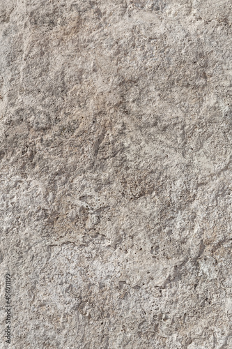 Empty rough  uneven texture of a gray concrete wall close up with copy space.