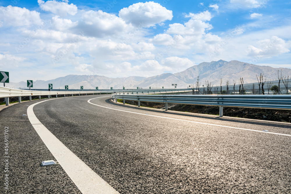 Naklejka premium Highway ground and mountain natural scenery under blue sky.Landscape and highway.Outdoor road background.