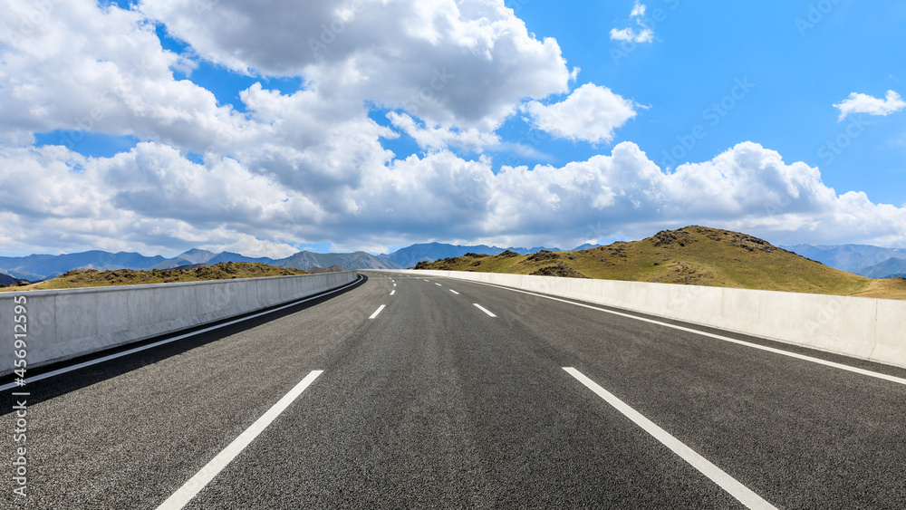 Highway ground and mountain natural scenery under blue sky.Landscape and highway.Outdoor road background.