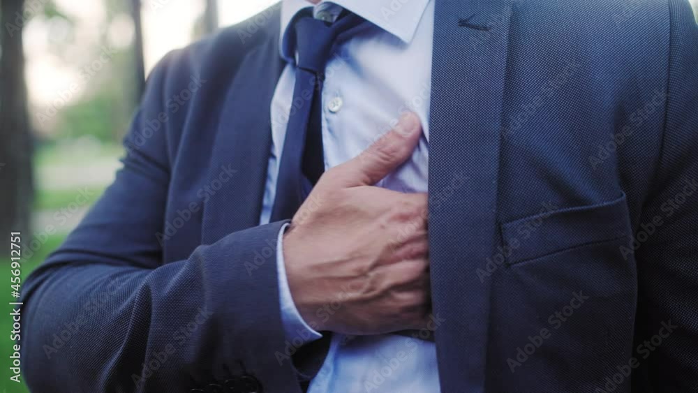 Vid o Stock Man In Business Suit Holding Chest Feeling Sharp Heart vid-o-stock-man-in-business-suit-holding-chest-feeling-sharp-heart