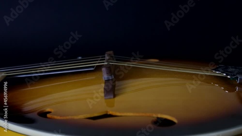 Mandolin, close camera movement on black background. Selective focus.