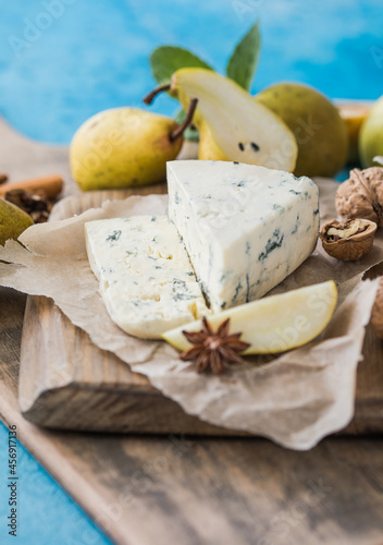 Gorgonzola picant Italian blue cheese, made from unskimmed cow's milk in North of Italy. Piece of blue mould cheese danablu,  roquefort with pear and walnuts photo