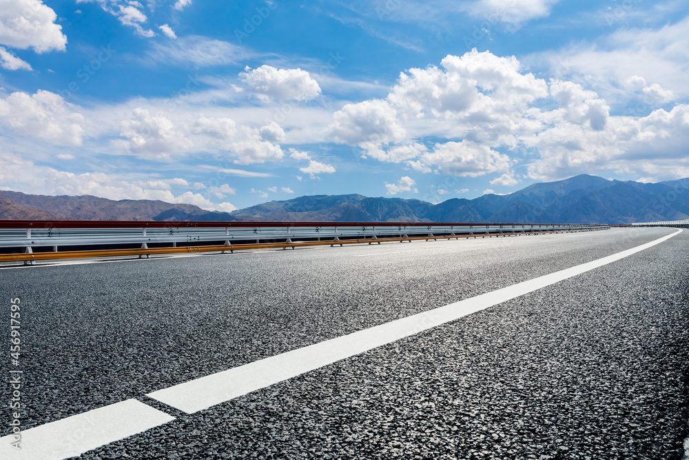 Fototapeta premium Highway ground and mountain natural scenery under blue sky.Landscape and highway.Outdoor road background.
