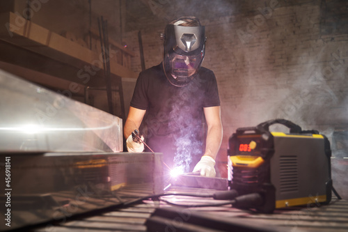 welding process. a welder in a helmet at work photo