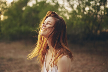 cheerful woman in a white dress in the field nature emotions freedom