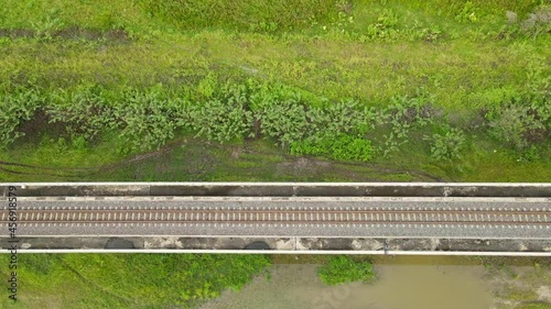 An aerial ascending footage showing the elevated railway on a wetland in Saraburi, Thailand. photo