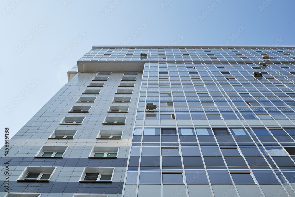facade of a high-rise modern building near the bottom facade of a high-rise modern building near the bottom