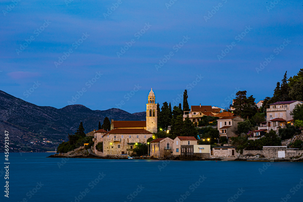 Widok na oświetlony klasztor Świętego Mikołaja na wyspie Korčula - obrazy, fototapety, plakaty 
