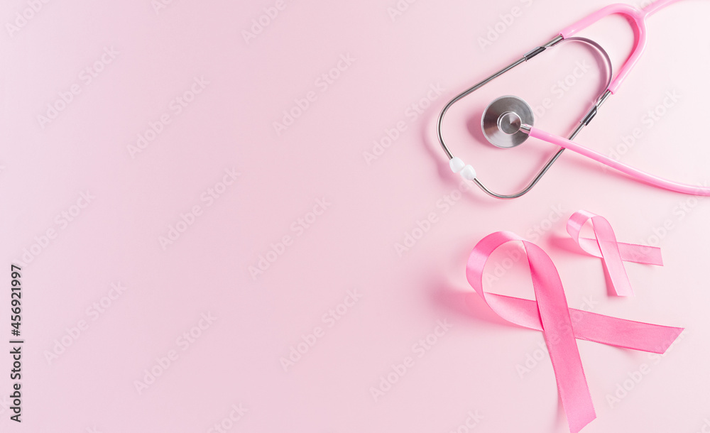 Pink ribbons and stethoscope on pastel background, Symbol of women's breast cancer awareness, Health care and medical concept. Pink ribbons and stethoscope on pastel background, Symbol of women's breast cancer awareness, Health care and medical concept.
