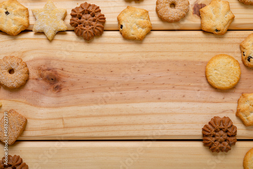 Composition of christmas cookies and copy space on wooden background