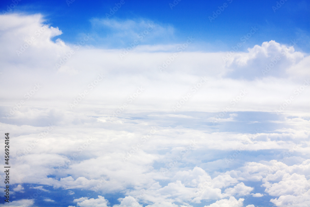 White clouds on blue sky background view from above, airplane flight landscape, beautiful aerial cloudscape, skies backdrop, fluffy cloud texture, sunny heaven, cloudy weather, cloudiness, copy space