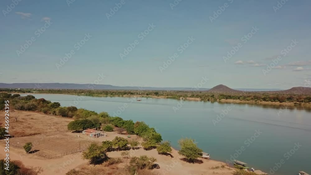 Dry, arid fields surround the Sao Francisco River during a drought caused by climate change. Aerial shot, push in. Dry, arid fields surround the Sao Francisco River during a drought caused by climate change. Aerial shot, push in.