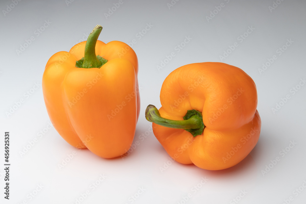 Two orange bell peppers isolated on white background Two orange bell peppers isolated on white background