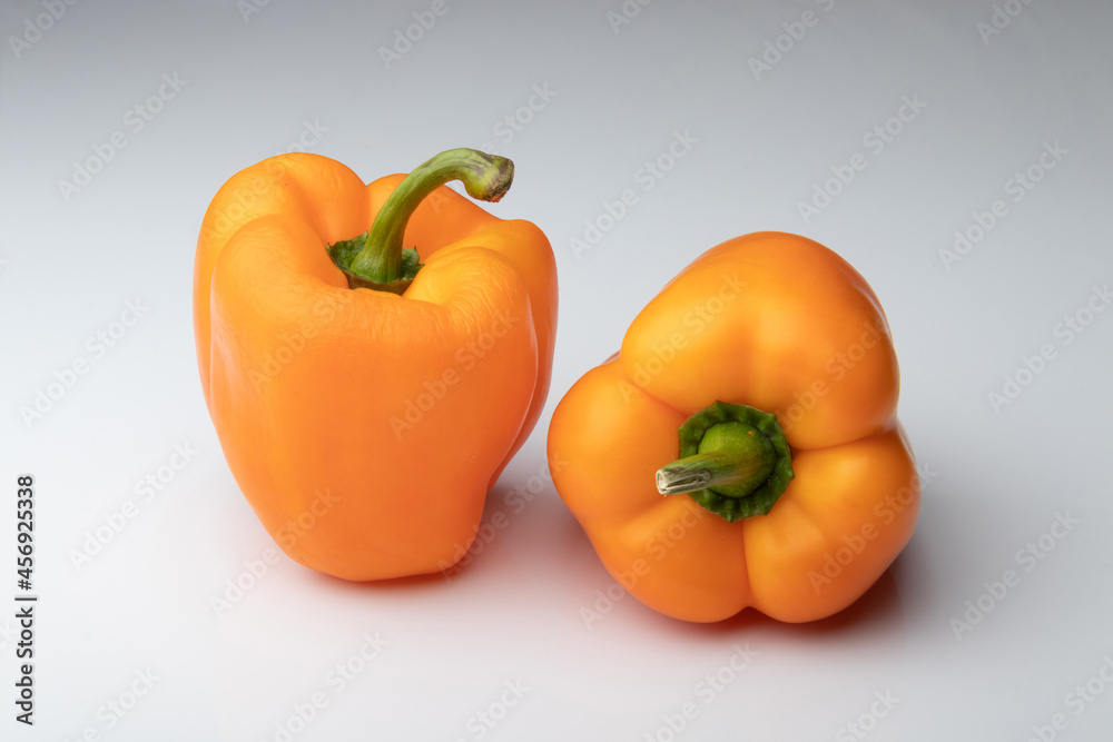Two orange bell peppers isolated on white background Two orange bell peppers isolated on white background
