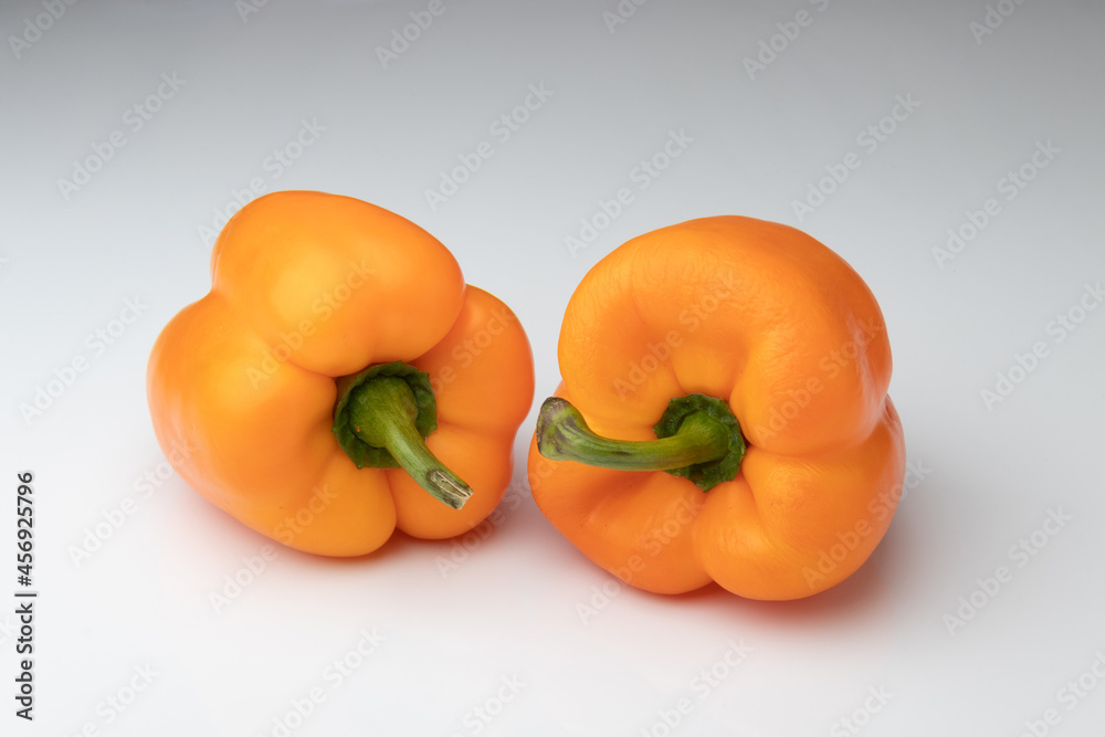 Two orange bell peppers isolated on white background Two orange bell peppers isolated on white background
