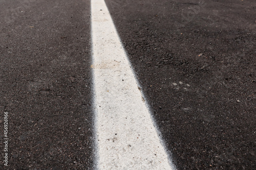 Wallpaper Mural Asphalt track just made with some dirt and its texture, with a white strip painted in the center of the image Torontodigital.ca