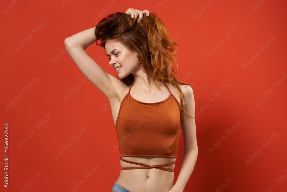 cheerful woman in a red t-shirt fashion hairstyle Glamor red background cheerful woman in a red t-shirt fashion hairstyle Glamor red background