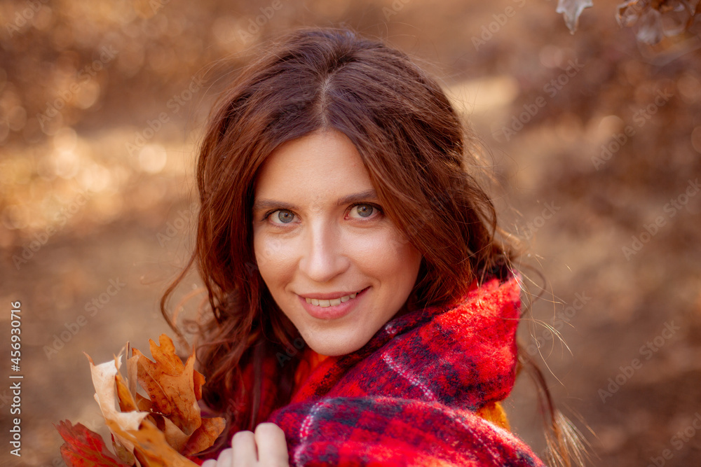 a young woman in an autumn park in an orange sweater a young woman in an autumn park in an orange sweater