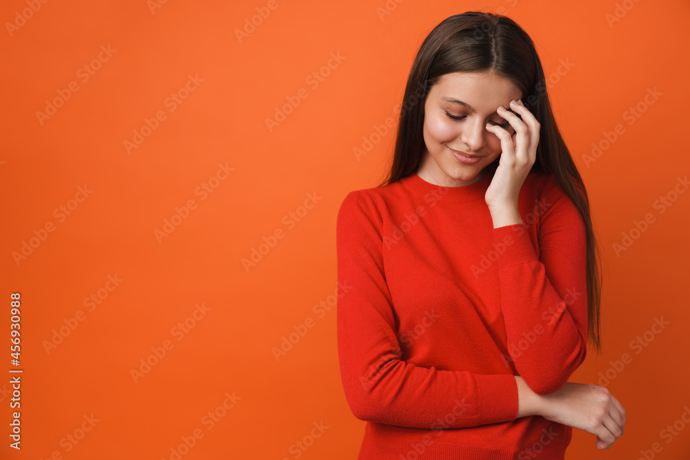 Young white brunette woman smiling while covering her face Young white brunette woman smiling while covering her face