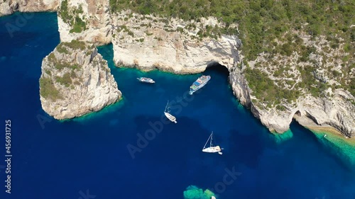 Aerial drone video of iconic Ortholithos and azure caves with deep turquoise sea where submarine Papanikolis was hiding during world war II, Paxos island, Ionian, Greece photo