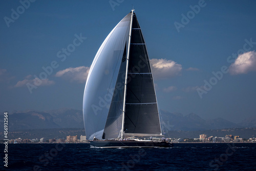 Photos Maxi yacht with white genaker sailing in the bay