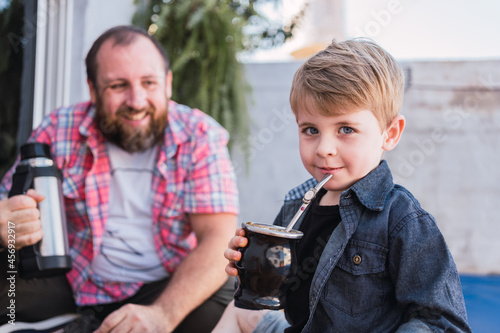 Charming boy with mate against smiling father