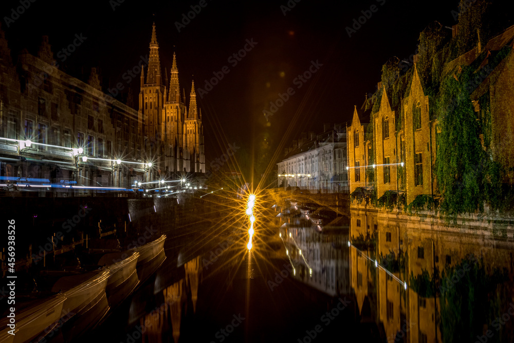 Artistic abstract zoom-burst long-exposure night photo from the downtown of Bruges, Belgium