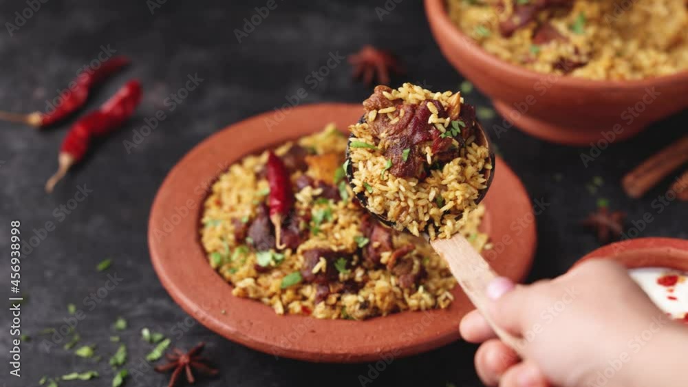 Hand Serving Mutton Gosht Biryani Spicy Indian Malabar lamb meat