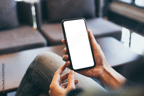 cell phone blank white screen mockup.woman hand holding texting using mobile on desk at office.background empty space for advertise.work people contact marketing business,technology