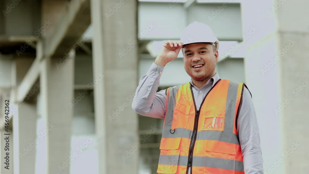 Asian engineer handsome man or architect looking construction with white safety helmet in construction site. Standing at highway concrete road site.
Asian engineer handsome man or architect looking construction with white safety helmet in construction site. Standing at highway concrete road site.