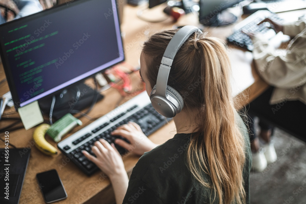 High angle view of female programmer working at startup company High angle view of female programmer working at startup company