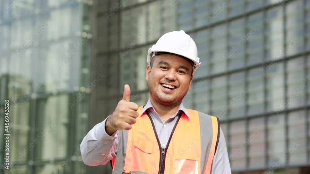 Asian engineer handsome man or architect looking camera with white safety helmet in construction site. Standing at modern building construction. Worker asian man showing thumbs up.
Asian engineer handsome man or architect looking camera with white safety helmet in construction site. Standing at modern building construction. Worker asian man showing thumbs up.