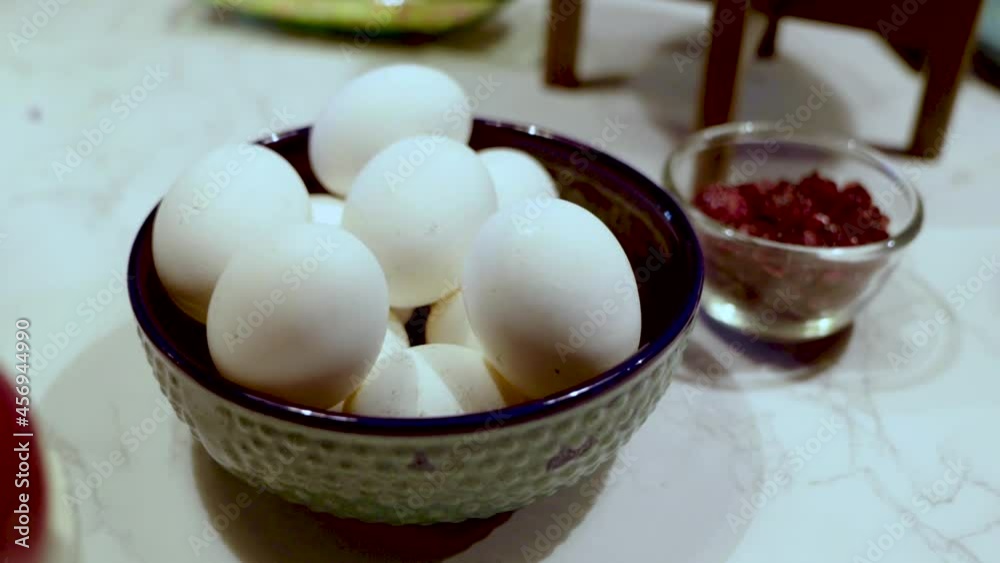 eggs in a black bowl on table