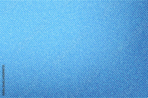 Background of realistic denim blue jeans texture. Fashion light blue canvas material wallpaper. Template for poster, banner. Image JPG