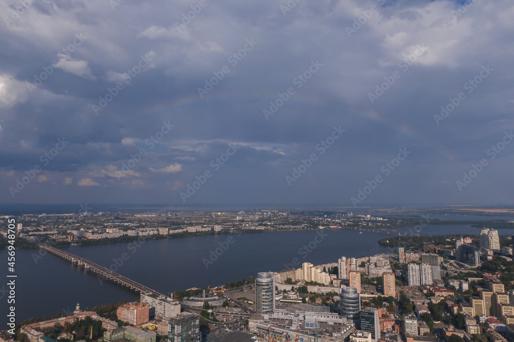 Beautiful double rainbow in the city after the rain. Photo from the drone. Rainbow against the blue sky